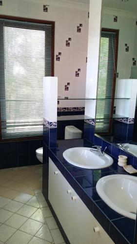 a bathroom with two sinks and a toilet at Unique spacious luxury villa in Jimbaran