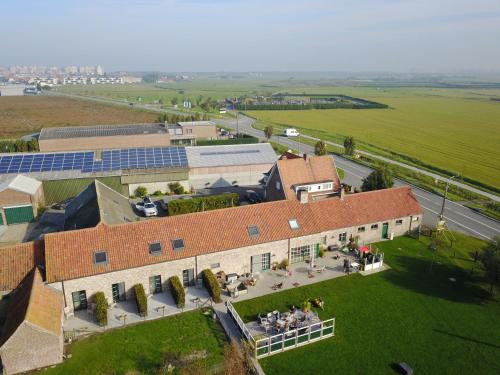 an overhead view of a building with a green field at Hoeve Langhof in Wenduine
