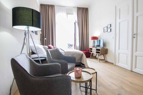 a living room with two chairs and a couch at Best Place and Comfort Apartments in Brno