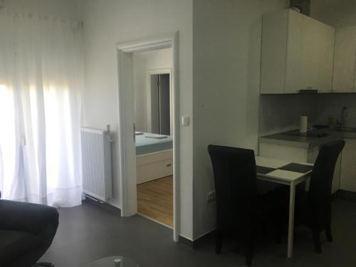 a kitchen and a dining room with a table and chairs at Apartment Doma in Međugorje