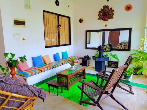 a living room with a couch and chairs at Leisure Villa in Colombo
