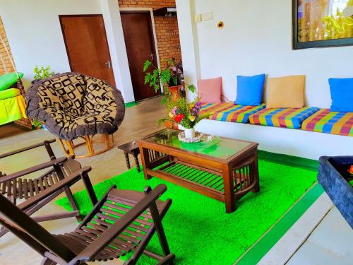 a living room with a couch and a table and chairs at Leisure Villa in Colombo