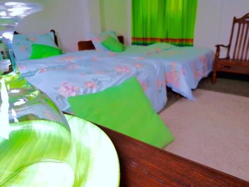 a bedroom with a bed and a table with a bottle at Leisure Villa in Colombo