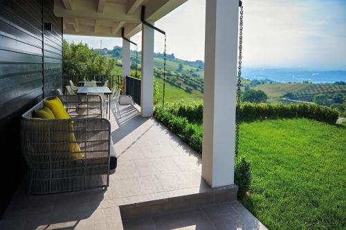 a patio with a table and chairs on a house at Idea 18 Boutique Hotel in Controguerra