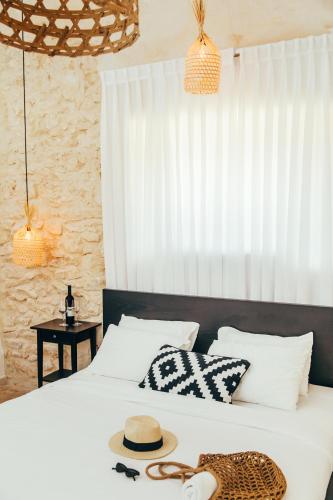 a bedroom with two beds and a hat on the bed at Hotel Anilevich Mansion in Beer Sheva