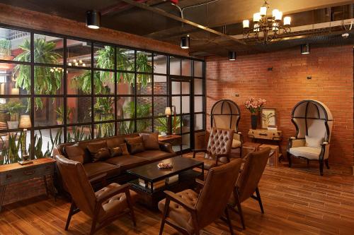 a living room with a couch and a table at W22 by Burasari in Bangkok