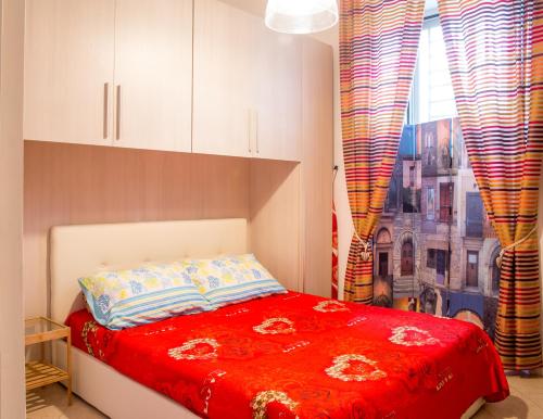 ナポリにあるVillino Chiaraのベッドルーム1室(赤いベッド1台、窓付)