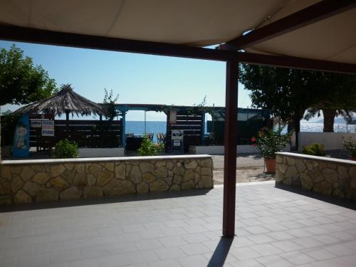 a view of the ocean from an outdoor patio at Akri Rooms in Akrata