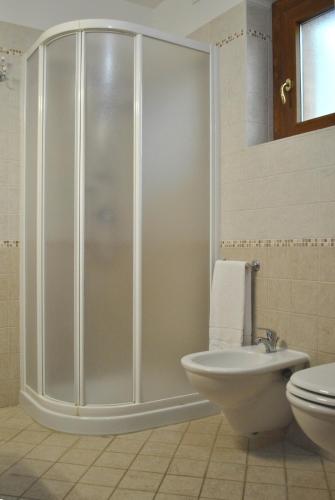a bathroom with a shower and a toilet and a sink at Hotel Villa San Giorgio in Poggibonsi