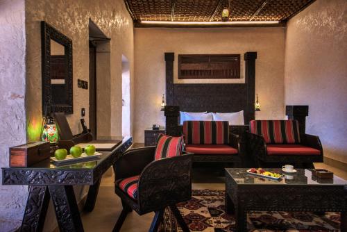 a living room with a couch and chairs in a room at Telal Resort Al Ain in Al Ain