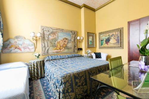 a bedroom with a bed with a painting on the wall at Hotel Celio in Rome