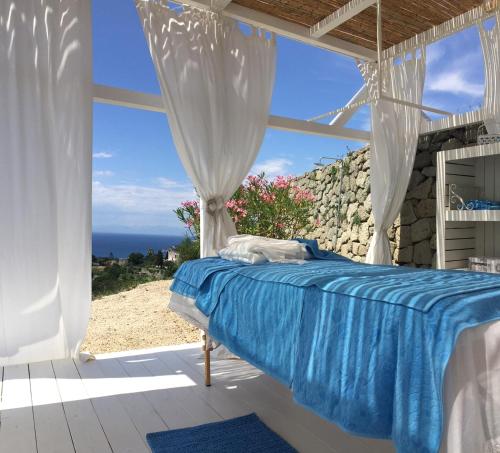 a bedroom with a bed with a view of the ocean at Tenuta C'est la Vie in Ischia