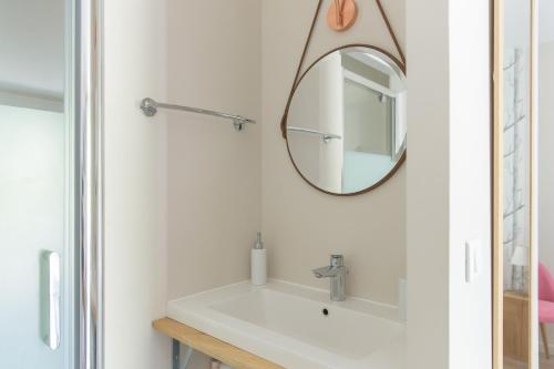 a bathroom with a sink and a mirror at Le Mas des Alexandrins in Uzès