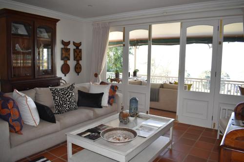a living room with a couch and a table at Southey House in Kloof