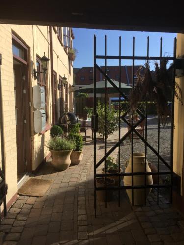 a courtyard with potted plants and a building at MilleBo - Like Home Studio Apartment in Aalborg