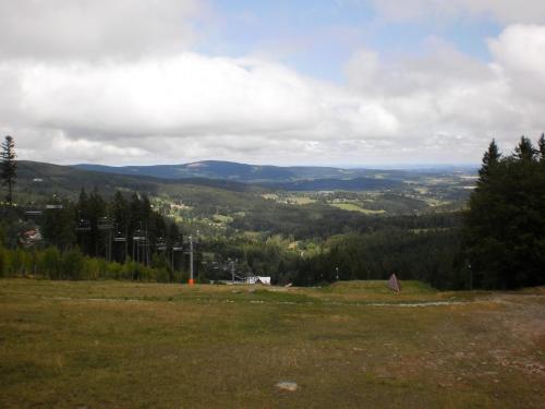 a grassy hill with a view of a valley at Apartman Kublovi in Vimperk
