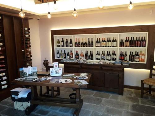 a wine shop with a large display of wine bottles at Antica Locanda San Leonardo 1554 in Ghivizzano