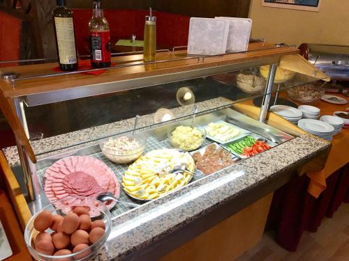 a buffet line with many different types of food at Alpský Hotel in Špindlerův Mlýn