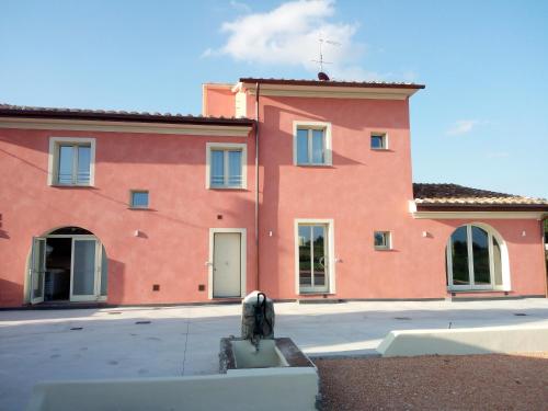 a large orange building with a white door at B&B SILVIA in Vecchiano