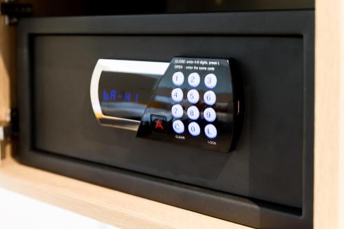a microwave with a remote control sitting on a shelf at Holiday Inn - the niu, Dairy Haarlem in Haarlem