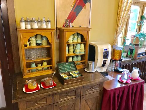 a kitchen with a counter with a counter top with food at Alpský Hotel in Špindlerův Mlýn