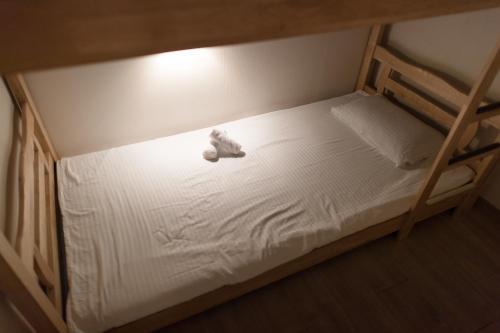 a teddy bear sitting on top of a bunk bed at Nol Guesthouse in Busan