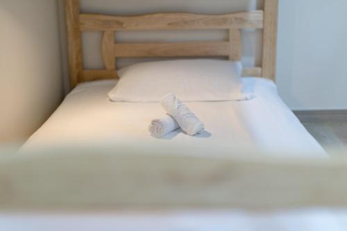 a roll of toilet paper sitting on top of a bed at Nol Guesthouse in Busan