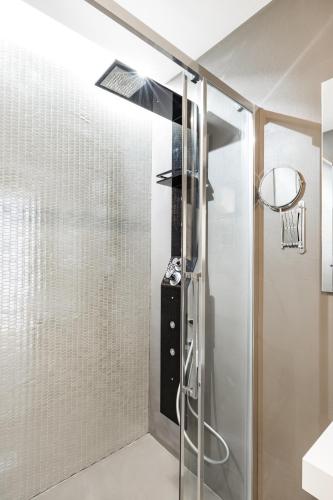 a shower with a glass door in a bathroom at A World Aparts - Barberini Boutique Hotel in Rome