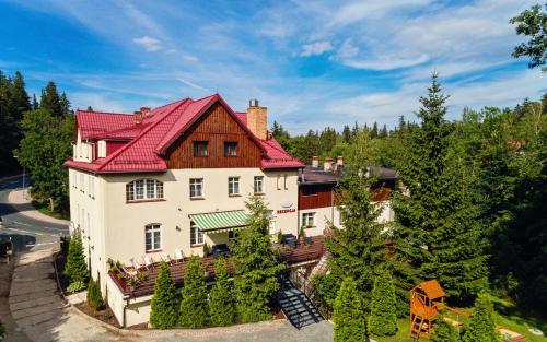 an aerial view of a house with a red roof at Leśny Dwór Karpacz Piekarnia Mio Padre Restauracja Mamma Mia in Karpacz