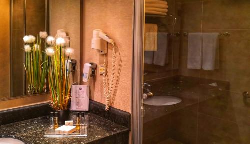 a bathroom with a sink and a phone at Hotel Anatolia in Bursa