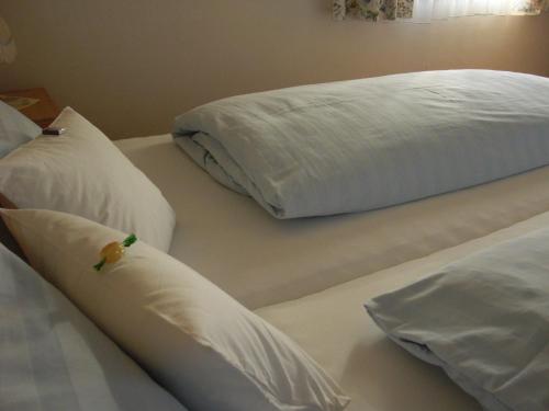 a white bed with two pillows on it at Weingut Schlafgut Genussgut Lorenz in Kitzeck im Sausal