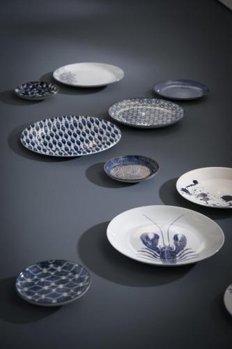 a group of blue and white plates on a table at Hotel Am Leuchtturm in Warnemünde