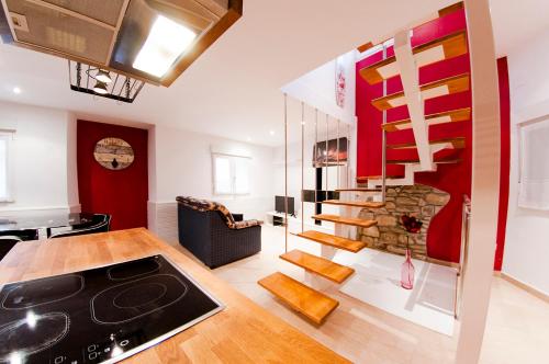 a kitchen and living room with a spiral staircase at APARTAMENTOs URDAIBAI in Busturia