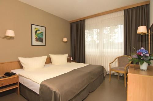 Säng eller sängar i ett rum på Hotel Logotel
