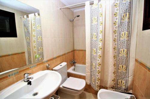 a bathroom with a sink and a toilet and a shower at Torre Mar 20-D in Benidorm