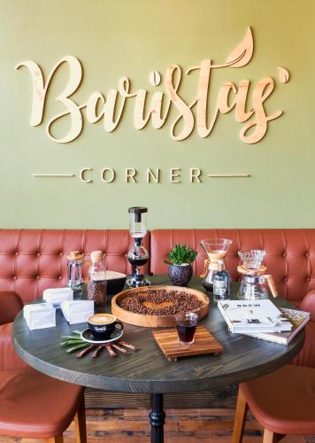 a restaurant with a table with a bench and a sign at Canal Central Hotel Business Bay in Dubai