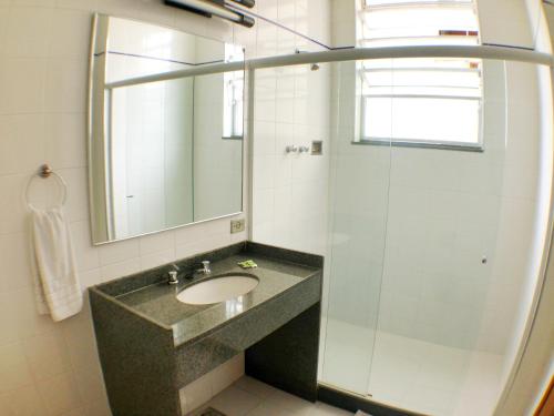 a bathroom with a sink and a mirror at Itajubá Hotel in Rio de Janeiro