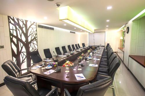 a large conference room with a long table and chairs at Ascott Palace Dhaka in Dhaka