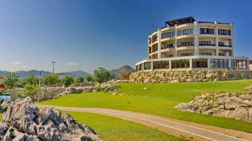 a large building on a hill with rocks at SL Panorama in Trebinje