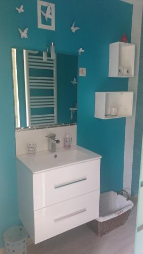 a bathroom with a sink and a mirror at Amour Aquitaine in Cambes