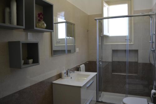 a bathroom with a sink and a shower at Angelo Holiday Home in Valderice