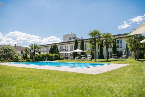 einem Pool vor einem Gebäude in der Unterkunft Hotel Mandelhof ***S in Appiano sulla Strada del Vino