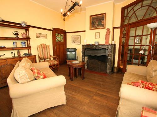 a living room with two couches and a fireplace at Quaint Holiday Home in Bouillon Ardennes in Bouillon