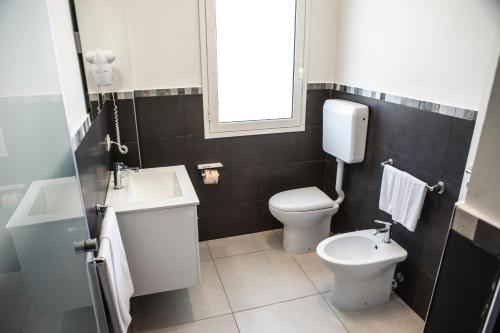 a bathroom with a toilet and a sink at Piano Monaco in Carini