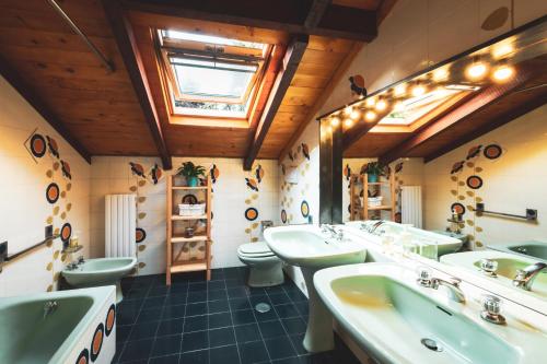 a bathroom with two sinks and two toilets at B&B Casa Danoi in Trinità