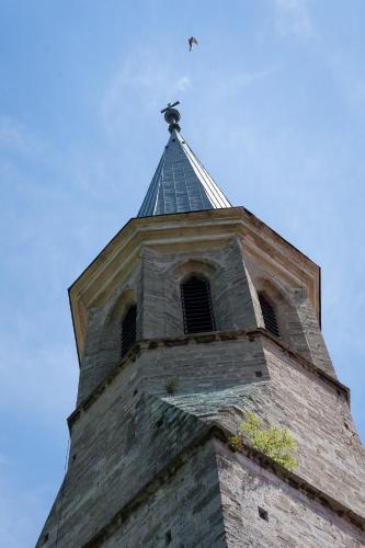 a church steeple with a cross on top of it at Schloss Gumpoldskirchen in Gumpoldskirchen