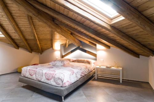 a attic bedroom with a bed and a skylight at Casa Vacanza Etna Dream in Zafferana Etnea