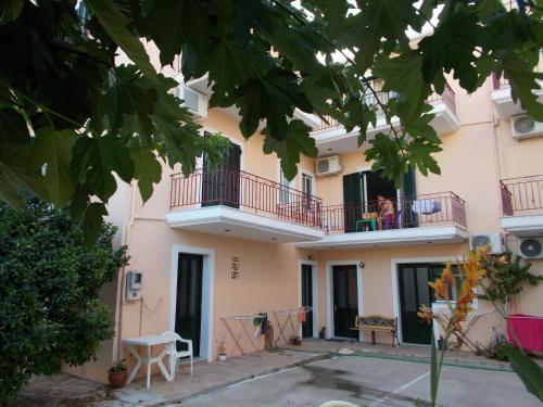 a building with people sitting on the balcony at Kohyli in Lefkada Town