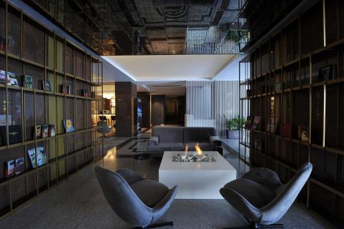 a living room with a white table and chairs at Crystal Palace Hotel in Bucharest