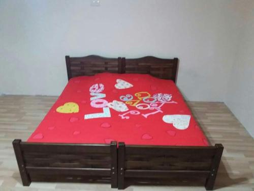 a bed with a red sheet with hello kitty on it at Guest House TiAni in Kobuleti